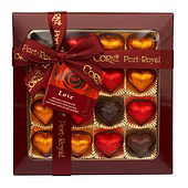 Square box of chocolates with gold, red and brown foils and dark red ribbon.