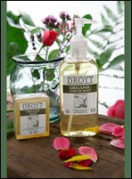 Droyt soap products surrounded by leaves and flowers.