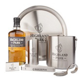 Bottle of Highland Park Scotch whisky with branded bar goods.