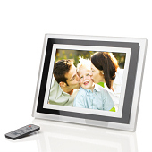 Photoframe on reflective surface with remote control and display of child with parents.