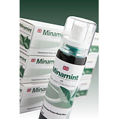 Three retail packs of minamint behind a bottle of the product.